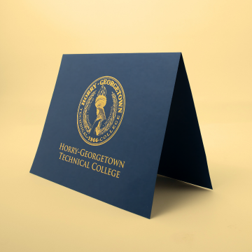 Navy printed holder with gold crest detail